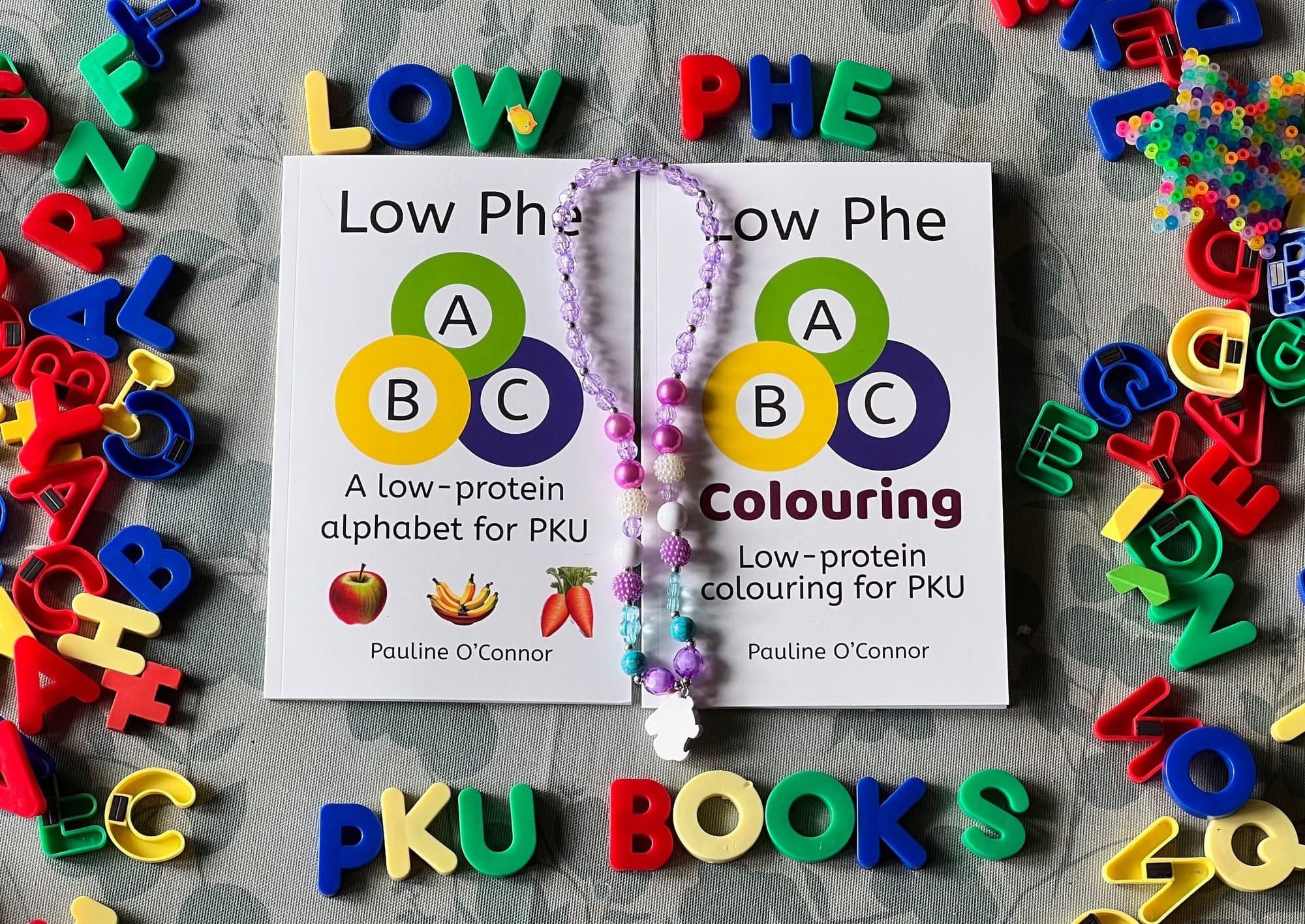 The ABC book and colouring books surrounded by colourful kid's ABC letters